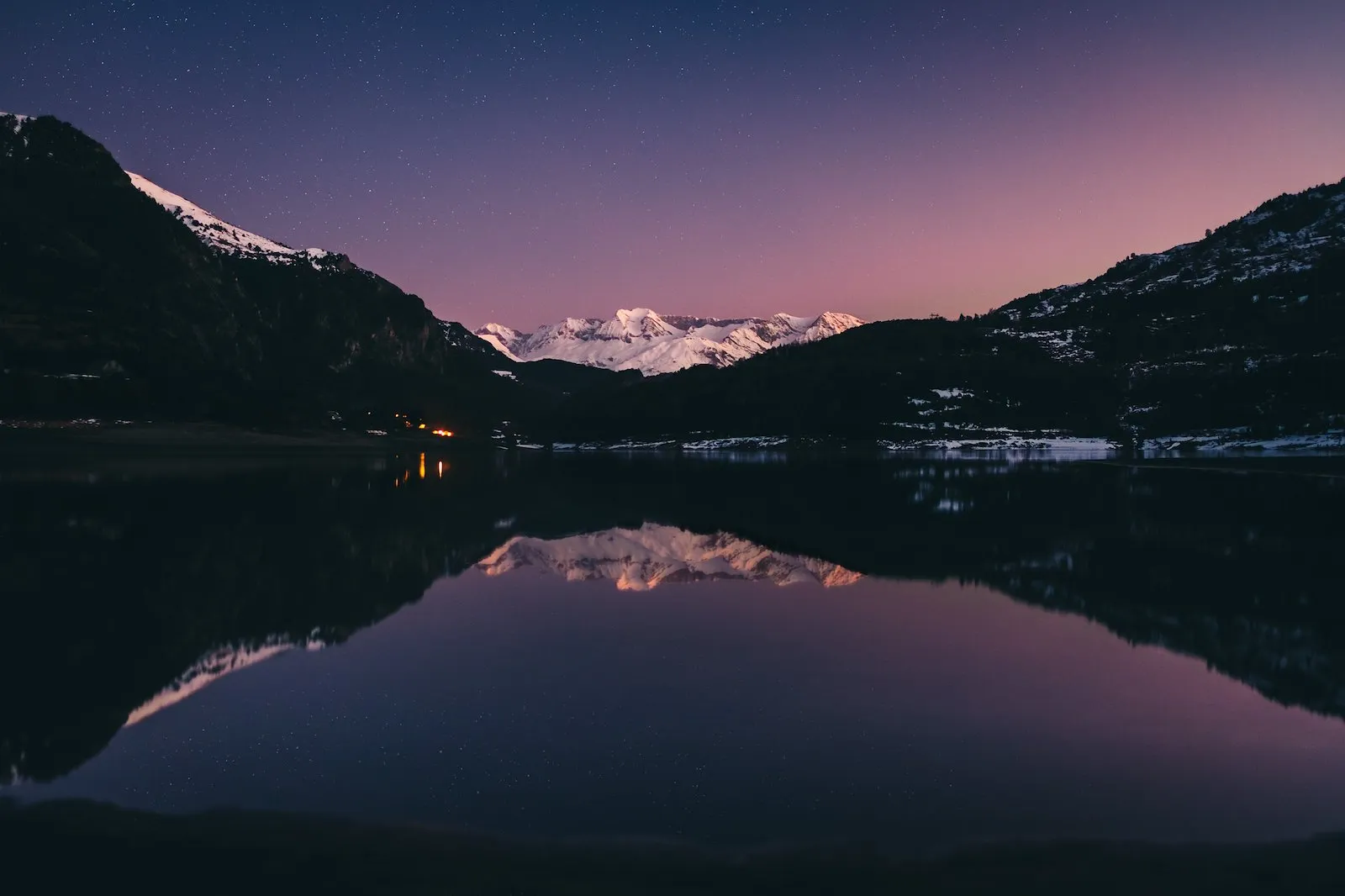 Snowy peaks reflected in a lake at blue hour, Pyrenees